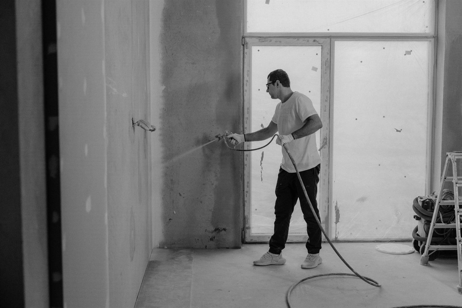 Painter spraying a wall